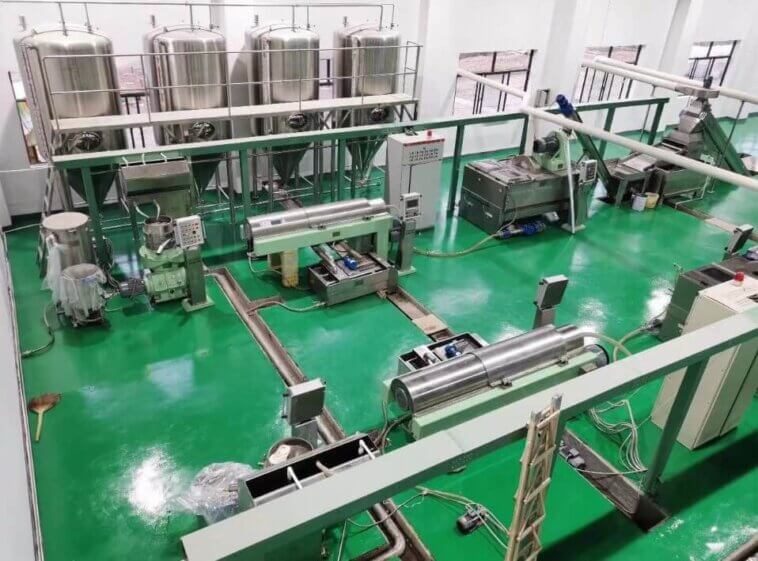 Extraction plant floor with stainless storage tanks, decanter centrifuges and process piping